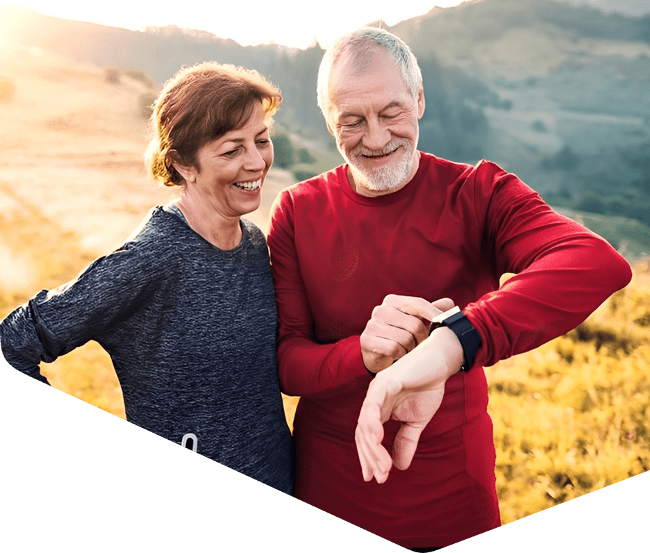 Senior couple smiling in outdoor setting.
