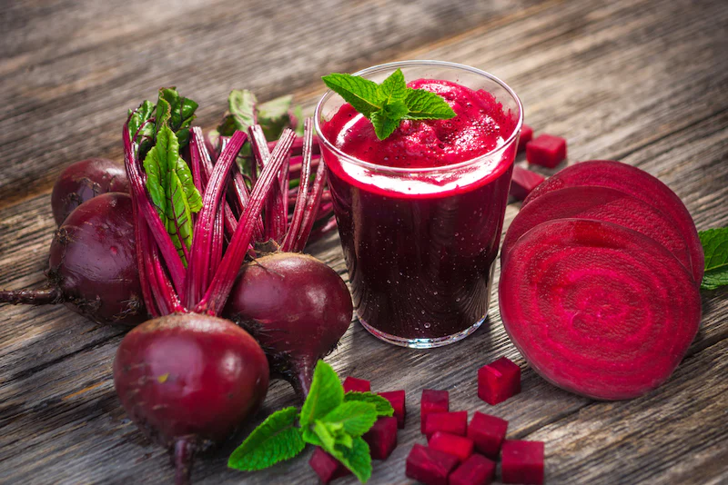 Fresh beet juice on wooden table