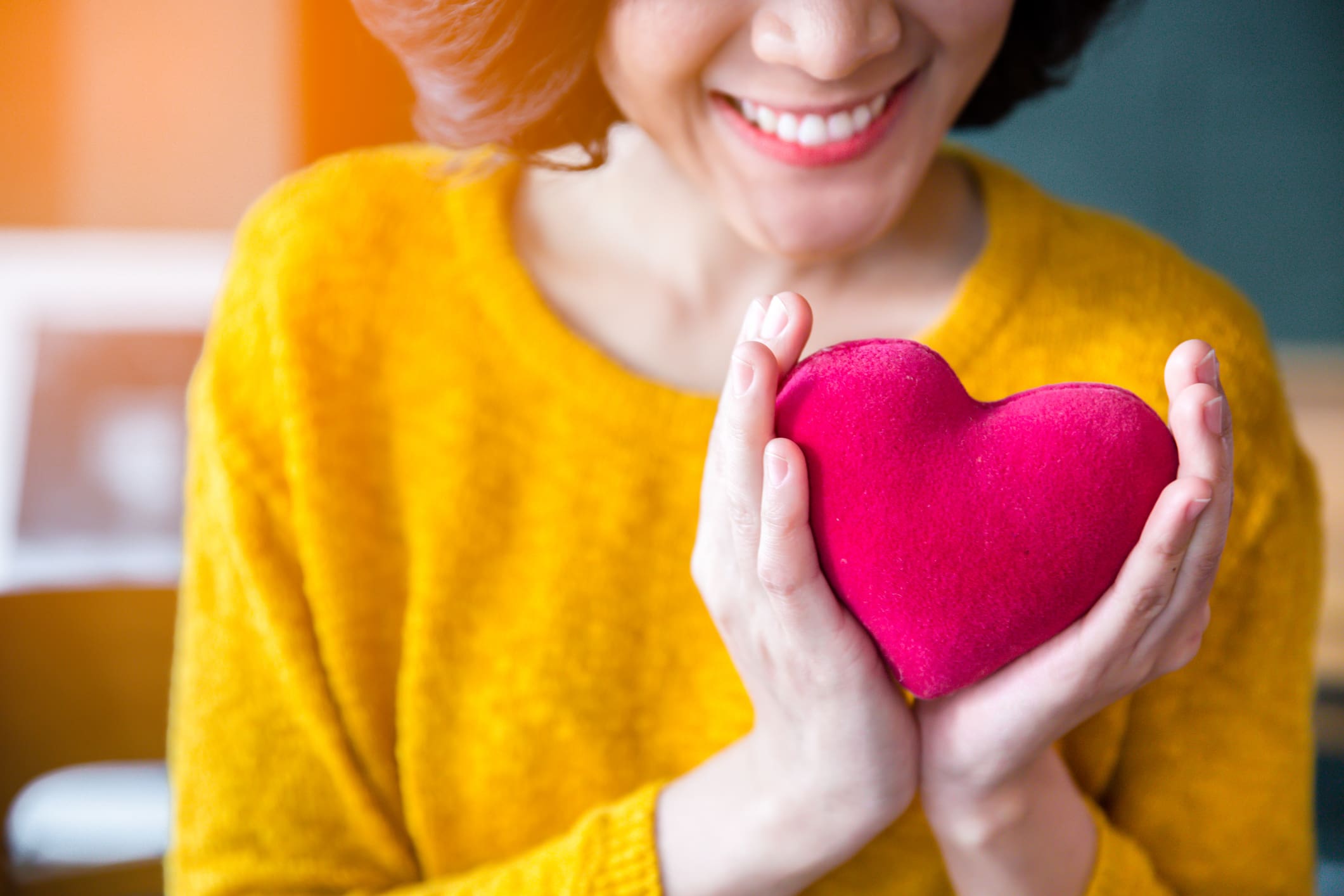 Woman in yellow sweater with heart