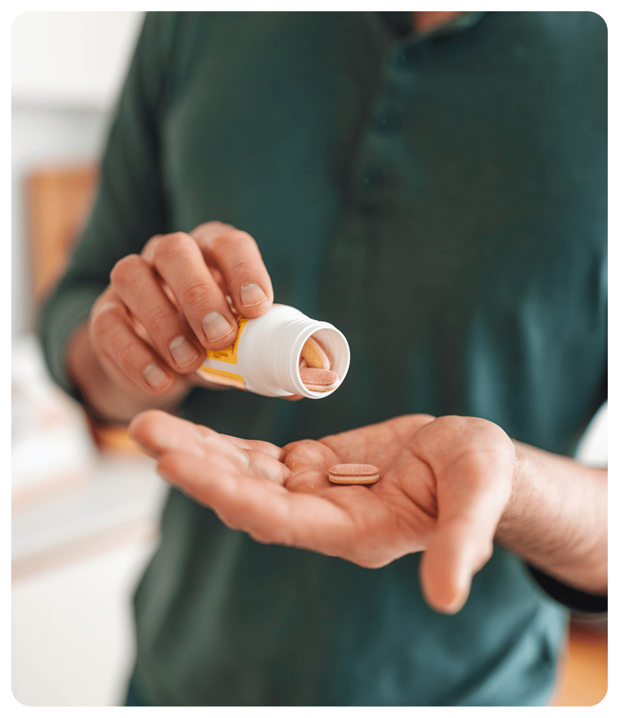 Man pouring pills into hand