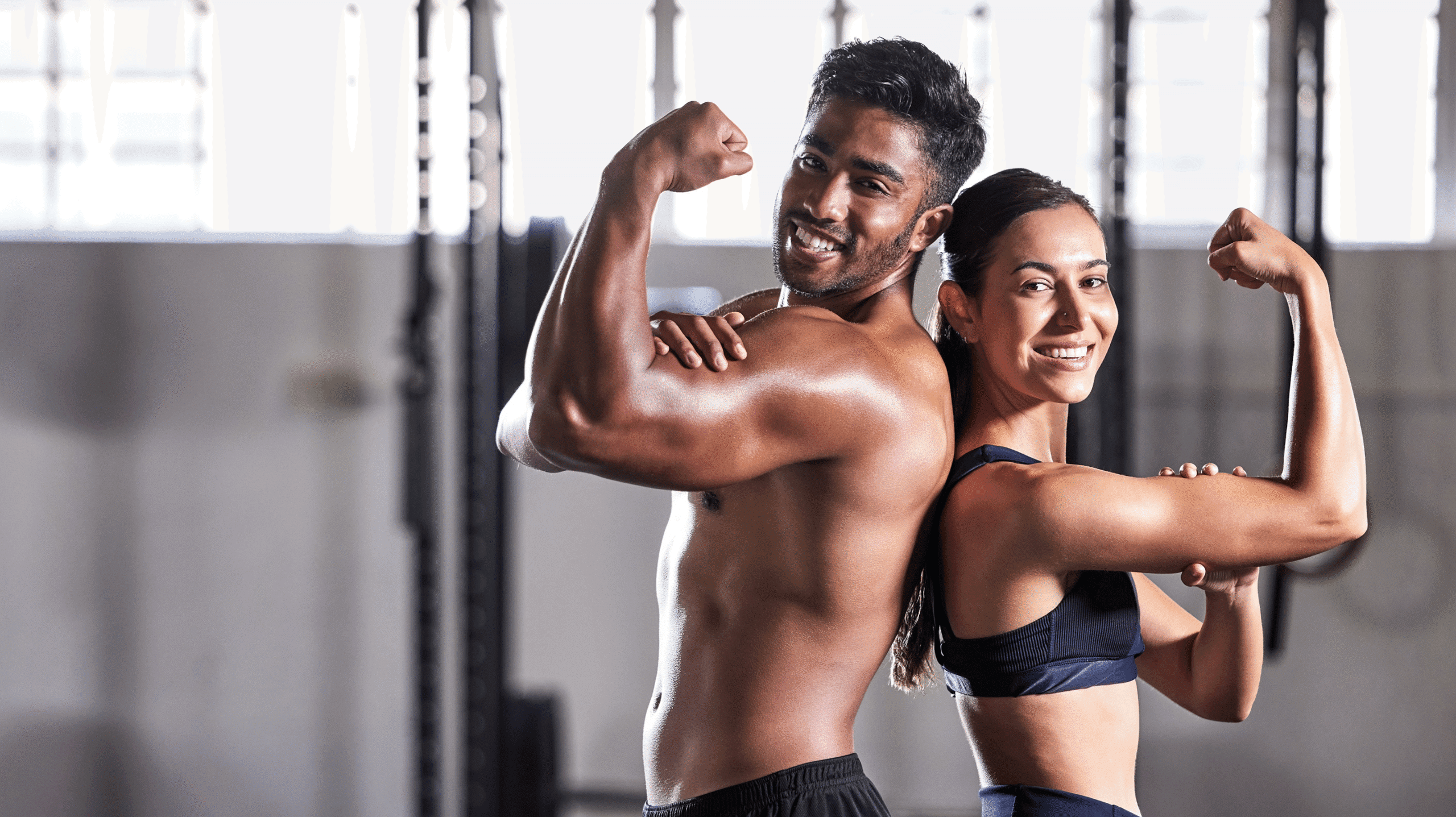 Smiling duo showing strong biceps