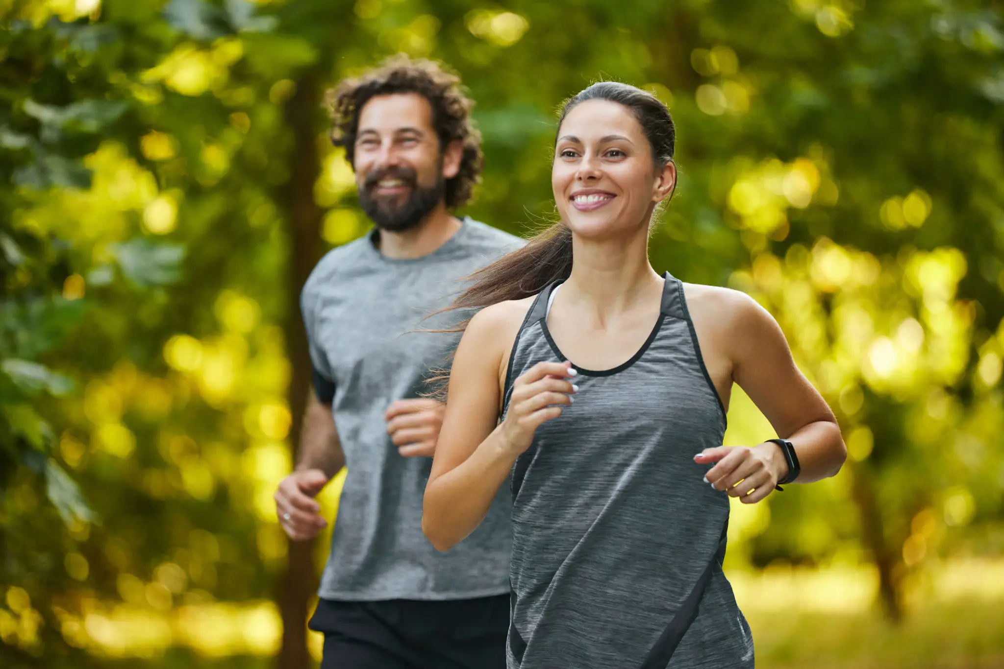 Two people jogging in a park.