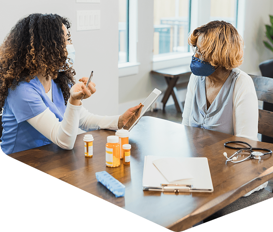 Healthcare consultation with masks and medication bottles.