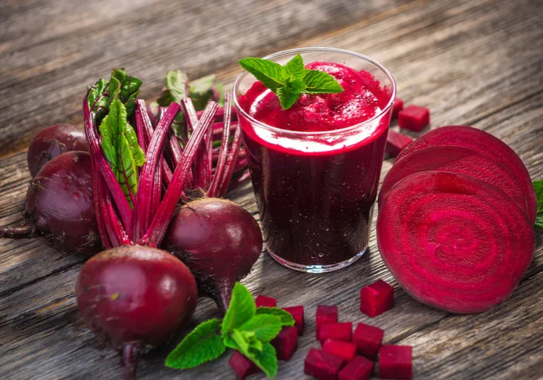 Fresh beet juice on wooden table